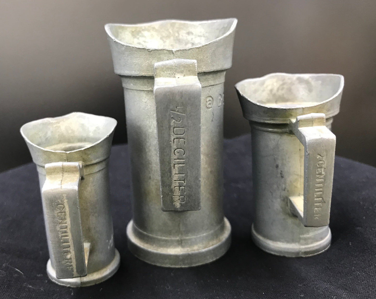 A lovely set of three vintage pewter measuring pitchers.