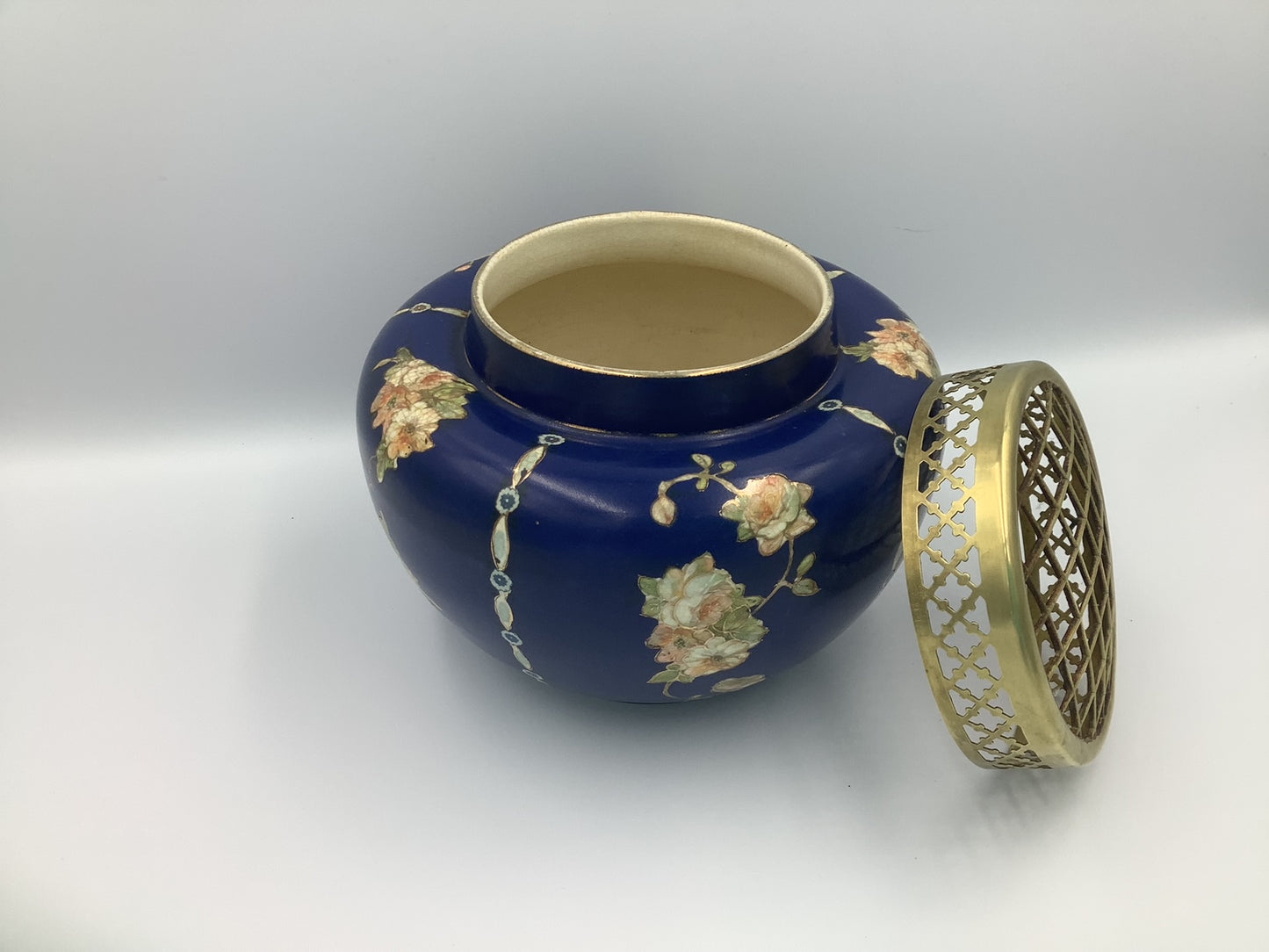 This lovely navy vase with pink/peach floral design circled in gold, and topped by a brass flower frog was made by Gibson & Sons in Burslem England between 1930 and 1950.