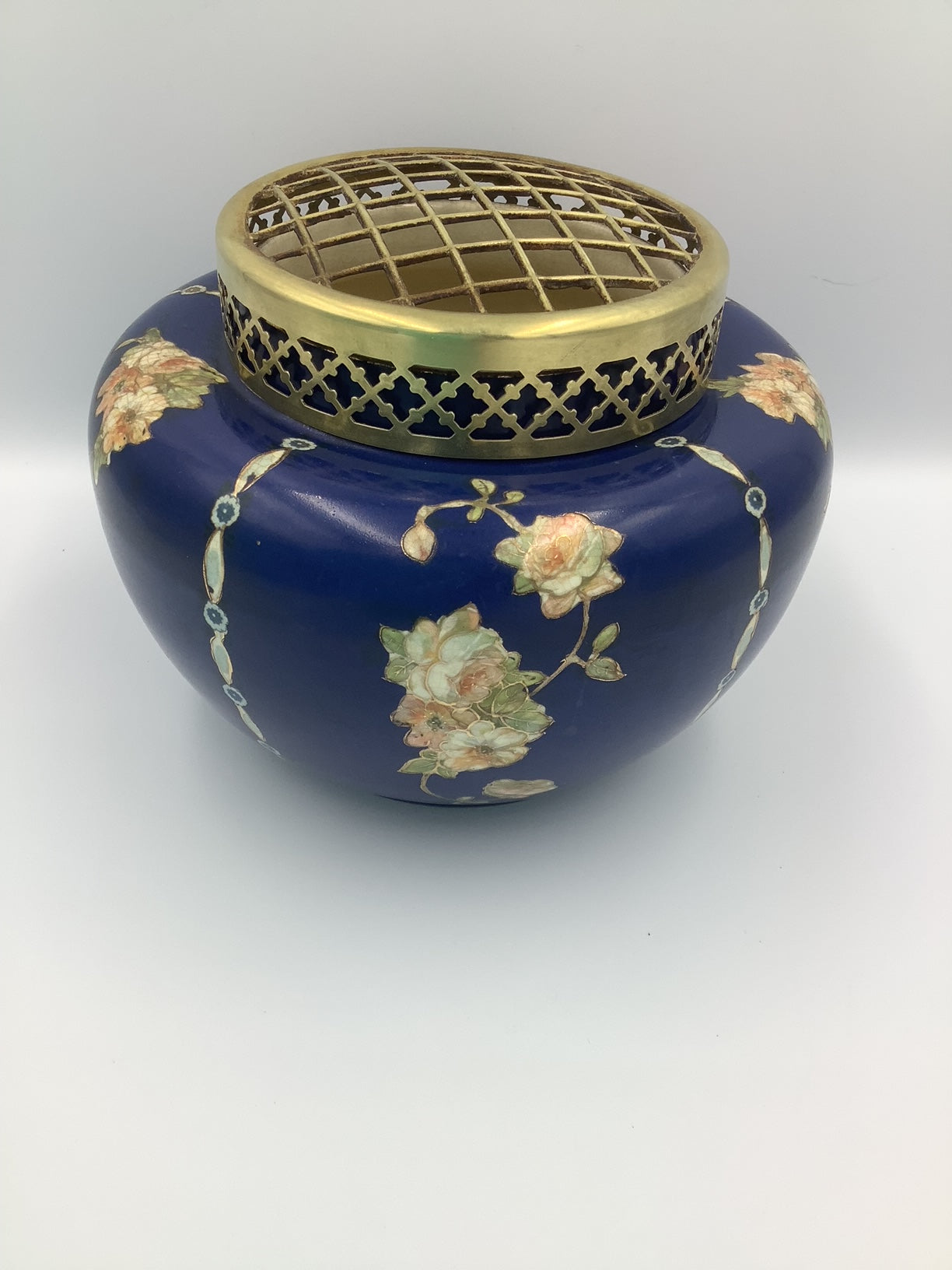 This lovely navy vase with pink/peach floral design circled in gold, and topped by a brass flower frog was made by Gibson & Sons in Burslem England between 1930 and 1950.