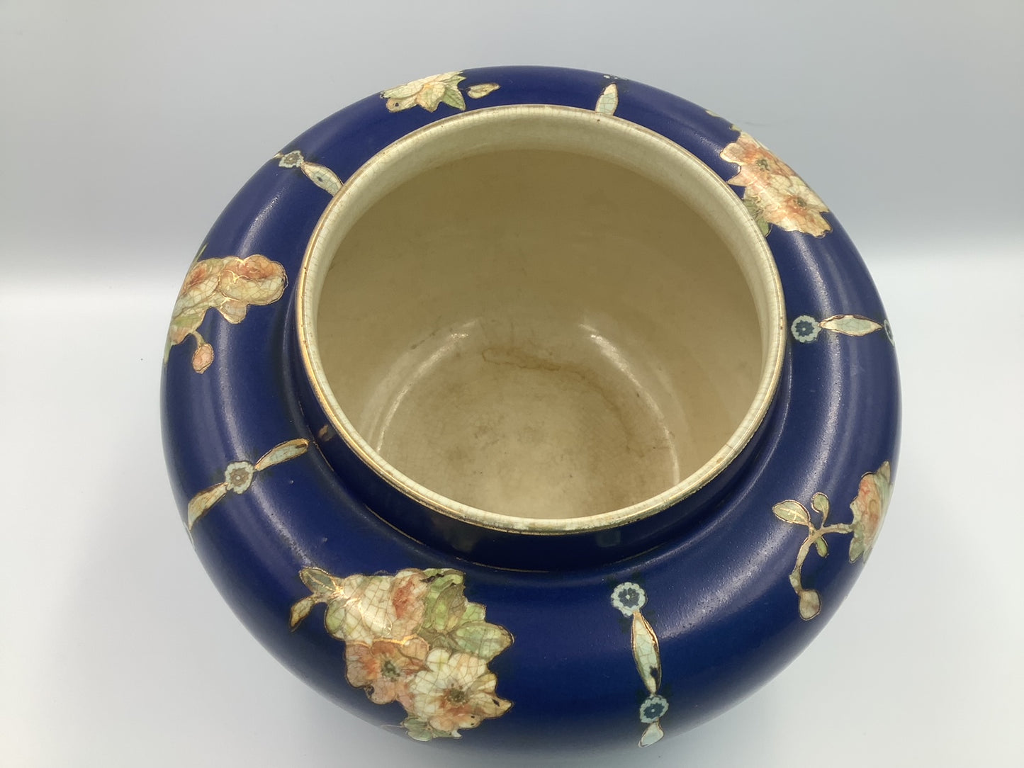 This lovely navy vase with pink/peach floral design circled in gold, and topped by a brass flower frog was made by Gibson & Sons in Burslem England between 1930 and 1950.